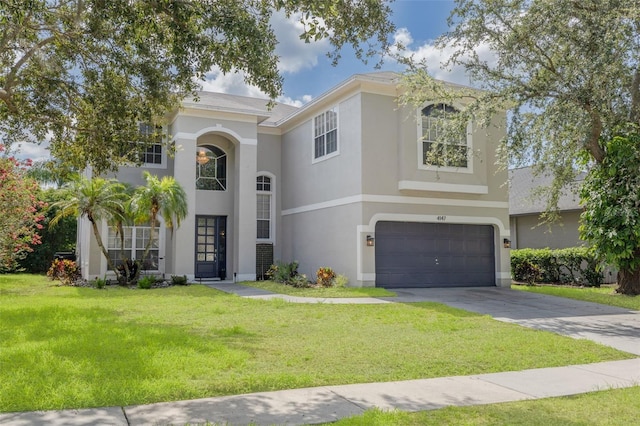 4147 Grandchamp Cir, Palm Harbor, FL 34685 - view of front of property with an attached garage, stucco siding, a front lawn, and driveway