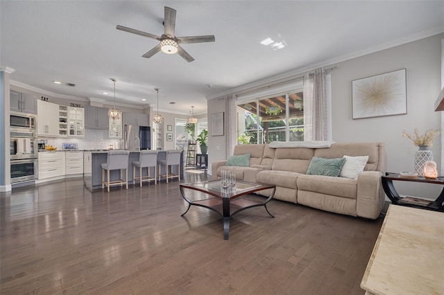 4147 Grandchamp Cir, Palm Harbor, FL 34685 - living area featuring a ceiling fan, ornamental molding, dark wood finished floors, recessed lighting, and a chandelier