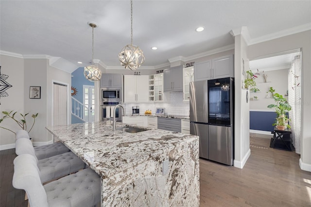 4147 Grandchamp Cir, Palm Harbor, FL 34685 - kitchen with appliances with stainless steel finishes, a chandelier, recessed lighting, wood finished floors, and backsplash