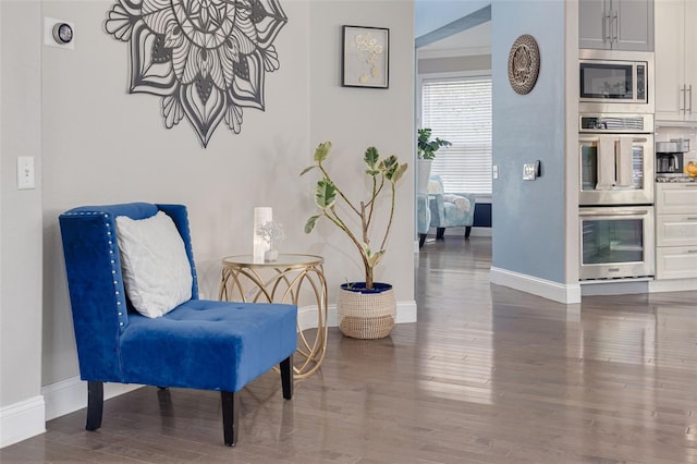 4147 Grandchamp Cir, Palm Harbor, FL 34685 - sitting room featuring baseboards and wood finished floors