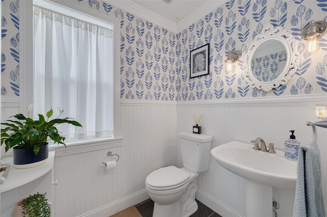 4147 Grandchamp Cir, Palm Harbor, FL 34685 - half bathroom featuring wallpapered walls, a wainscoted wall, healthy amount of natural light, and ornamental molding