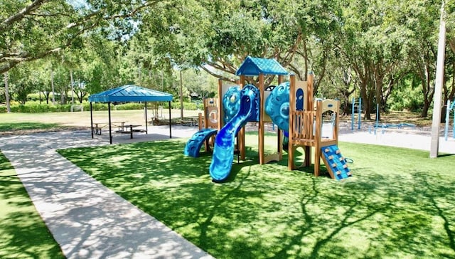 4147 Grandchamp Cir, Palm Harbor, FL 34685 - communal playground with view of wooded area and a yard
