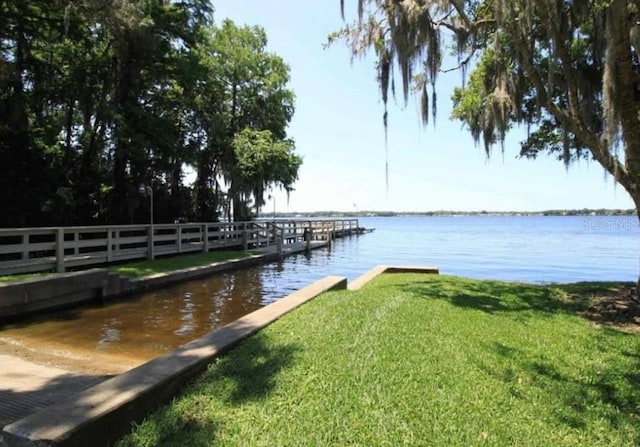 4147 Grandchamp Cir, Palm Harbor, FL 34685 - dock area with a water view and a lawn