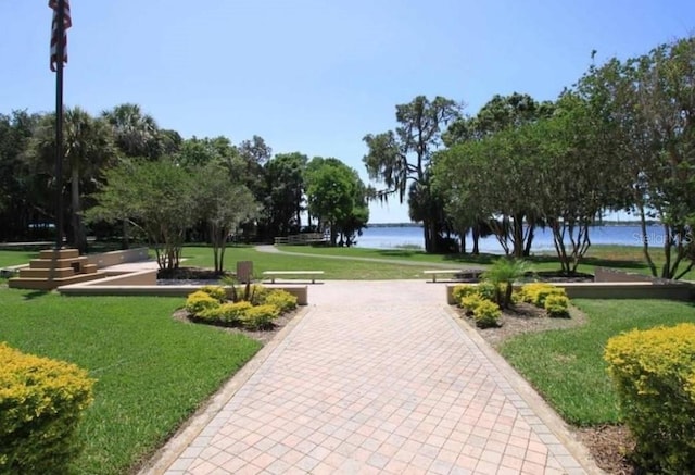 4147 Grandchamp Cir, Palm Harbor, FL 34685 - view of community with a water view and a yard