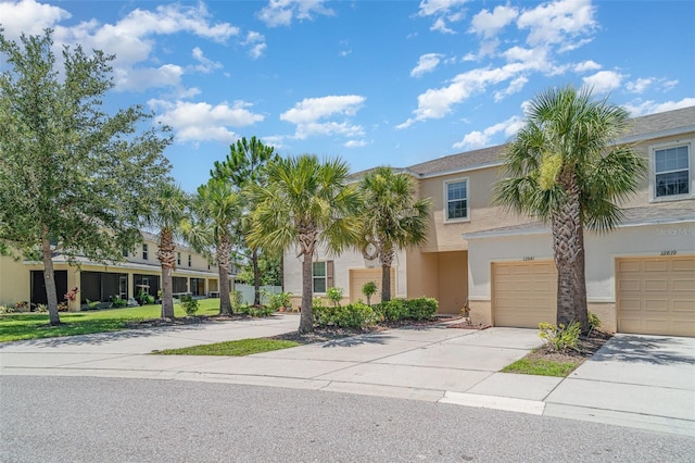 12841 Buffalo Run Dr, Gibsonton, FL 33534 - view of front facade featuring stucco siding, driveway, and an attached garage