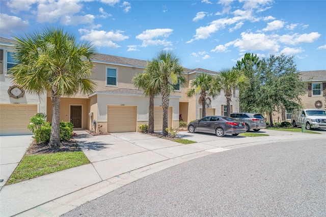 12841 Buffalo Run Dr, Gibsonton, FL 33534 - townhome / multi-family property with stucco siding, driveway, and an attached garage