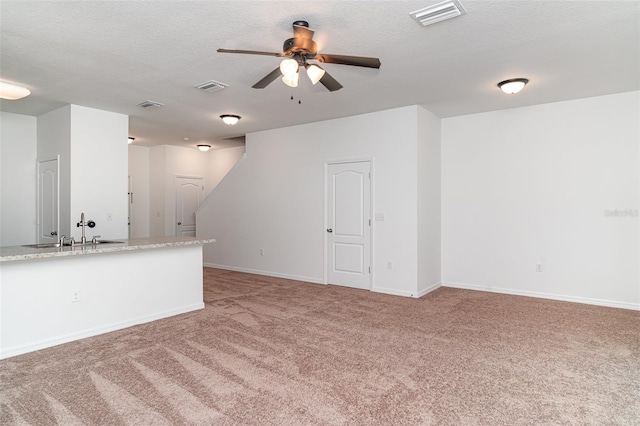 12841 Buffalo Run Dr, Gibsonton, FL 33534 - unfurnished living room with a ceiling fan, light colored carpet, and a textured ceiling