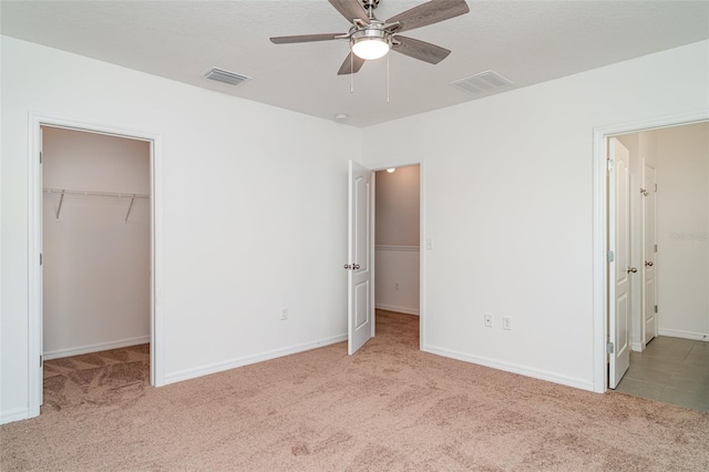 12841 Buffalo Run Dr, Gibsonton, FL 33534 - unfurnished bedroom with carpet flooring, a spacious closet, a closet, and a ceiling fan