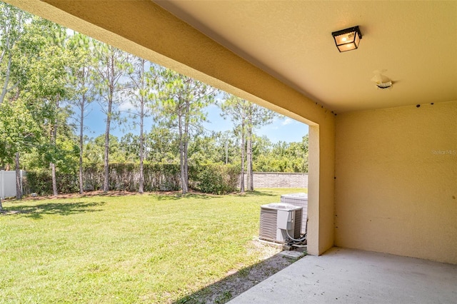 12841 Buffalo Run Dr, Gibsonton, FL 33534 - fenced backyard featuring a patio and view of scattered trees