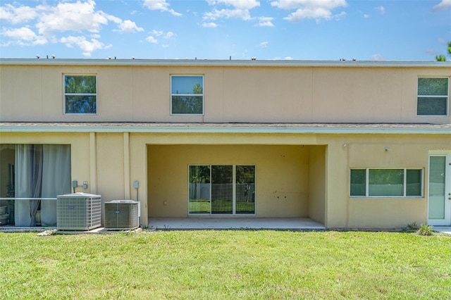 12841 Buffalo Run Dr, Gibsonton, FL 33534 - back of house featuring a patio, a yard, and stucco siding
