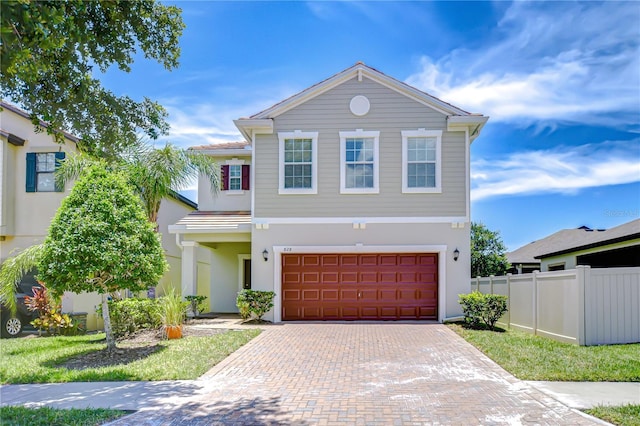 828 Terra Vista St, Brandon, FL 33511 - view of front of home featuring an attached garage, decorative driveway, and stucco siding