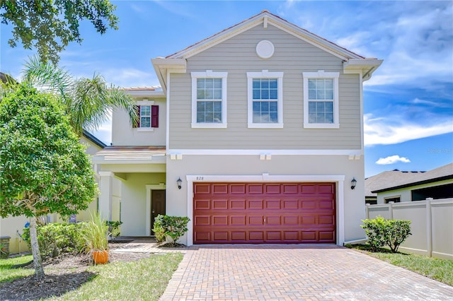 828 Terra Vista St, Brandon, FL 33511 - view of front of home featuring stucco siding, decorative driveway, and an attached garage