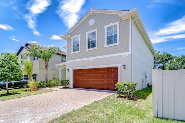 828 Terra Vista St, Brandon, FL 33511 - view of front of house featuring an attached garage, decorative driveway, and stucco siding