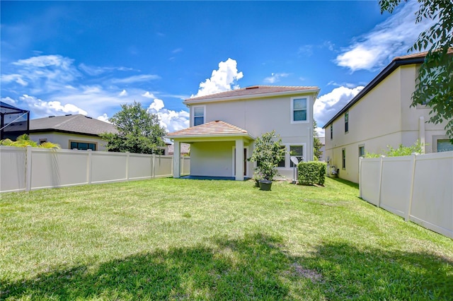828 Terra Vista St, Brandon, FL 33511 - back of house with a tiled roof, a fenced backyard, and stucco siding