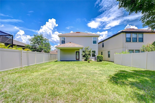 828 Terra Vista St, Brandon, FL 33511 - rear view of house featuring stucco siding, a fenced backyard, and a tile roof