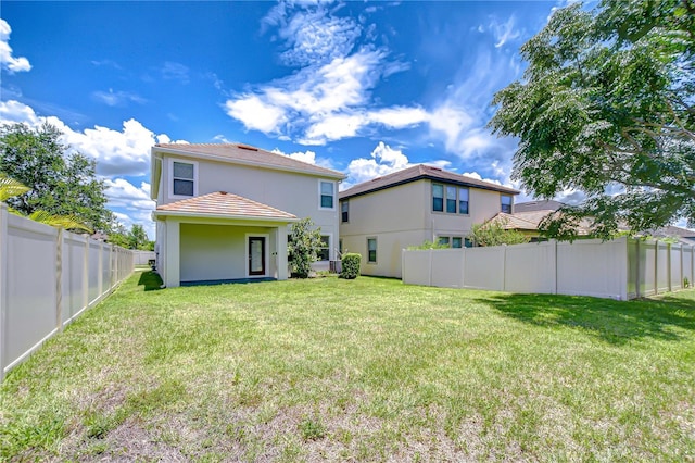 828 Terra Vista St, Brandon, FL 33511 - rear view of property featuring a tile roof, stucco siding, and a fenced backyard