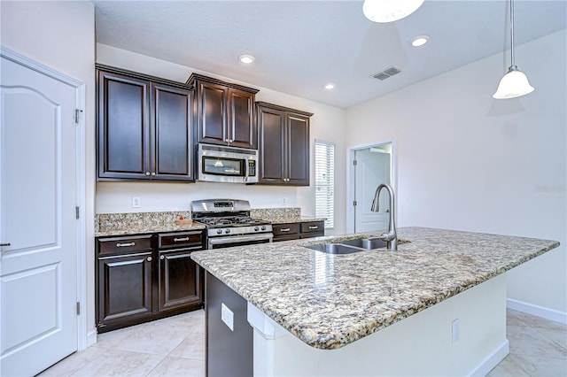 828 Terra Vista St, Brandon, FL 33511 - kitchen featuring appliances with stainless steel finishes, light stone counters, hanging light fixtures, light tile patterned floors, and recessed lighting