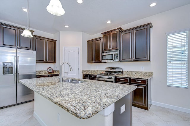 828 Terra Vista St, Brandon, FL 33511 - kitchen with stainless steel appliances, dark brown cabinets, light tile patterned floors, and recessed lighting