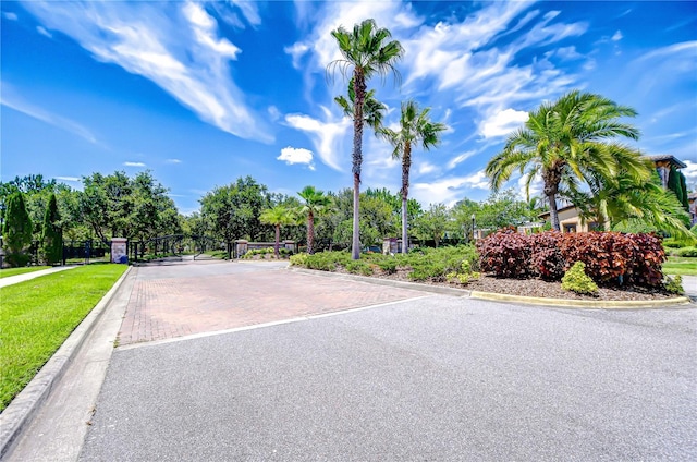 828 Terra Vista St, Brandon, FL 33511 - view of asphalt road featuring curbs and a gated entry