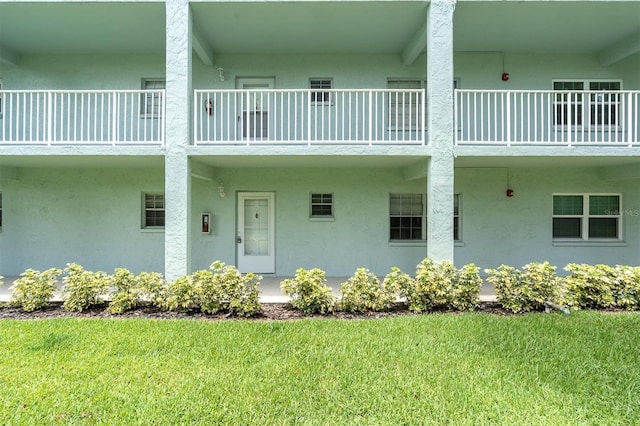 1706 Belleair Forest Dr Unit 146, Belleair, FL 33756 - view of exterior entry featuring a balcony and stucco siding