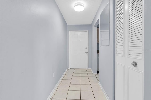 1706 Belleair Forest Dr Unit 146, Belleair, FL 33756 - corridor with baseboards and light tile patterned flooring