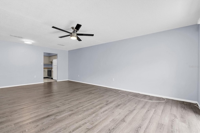 1706 Belleair Forest Dr Unit 146, Belleair, FL 33756 - spare room featuring wood finished floors and a ceiling fan