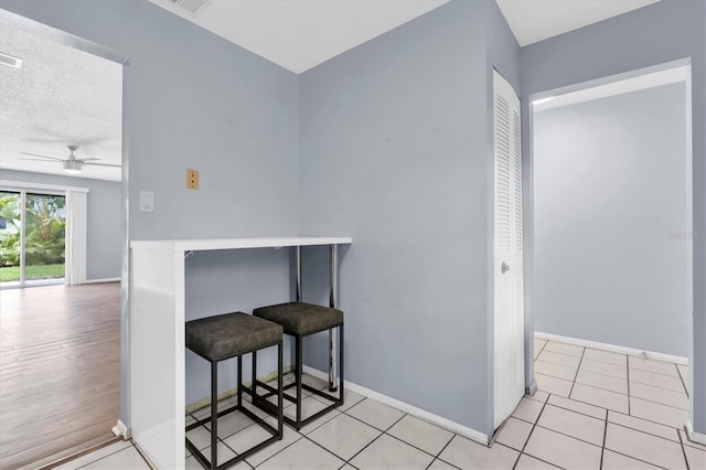 1706 Belleair Forest Dr Unit 146, Belleair, FL 33756 - kitchen with ceiling fan and a kitchen bar