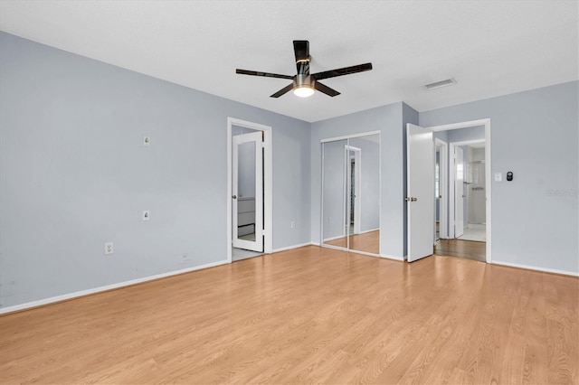 1706 Belleair Forest Dr Unit 146, Belleair, FL 33756 - unfurnished bedroom with light wood-style flooring and a ceiling fan