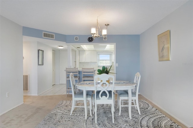 4775 Cove Cir Unit 803, Saint Petersburg, FL 33708 - dining area featuring a chandelier and light carpet