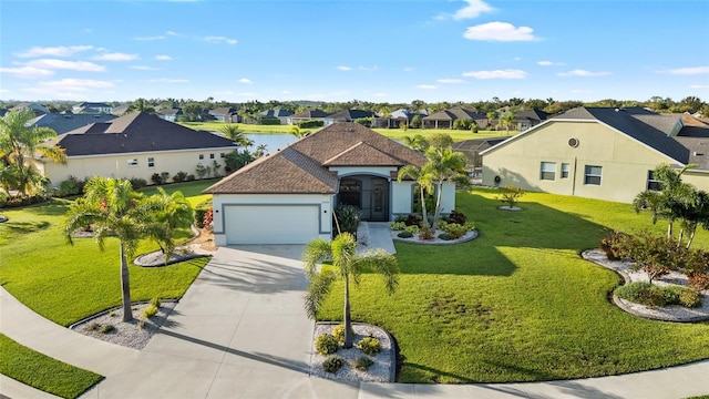 12830 24th Street Cir E, Parrish, FL 34219 - view of front facade featuring a residential view, concrete driveway, a garage, a front lawn, and stucco siding
