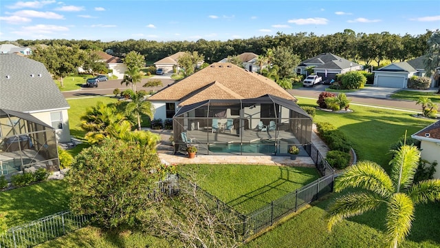 12830 24th Street Cir E, Parrish, FL 34219 - back of property featuring a fenced backyard, a patio area, a residential view, and a lanai