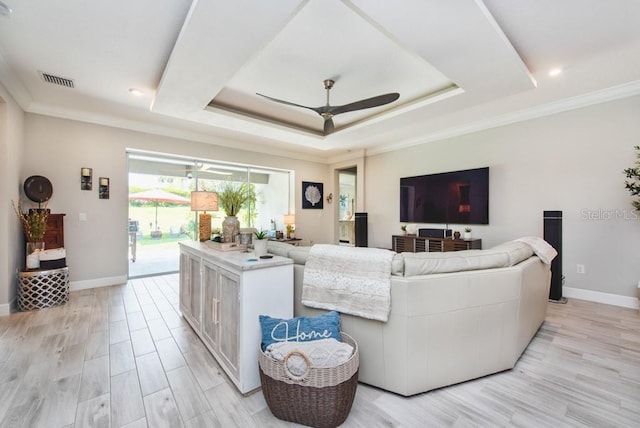 4906 Los Robles Ct, Palmetto, FL 34221 - living room featuring ceiling fan, a tray ceiling, light wood-style floors, and crown molding