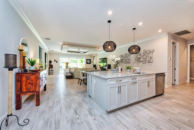4906 Los Robles Ct, Palmetto, FL 34221 - kitchen featuring stainless steel dishwasher, open floor plan, ornamental molding, light wood-style floors, and a kitchen island with sink