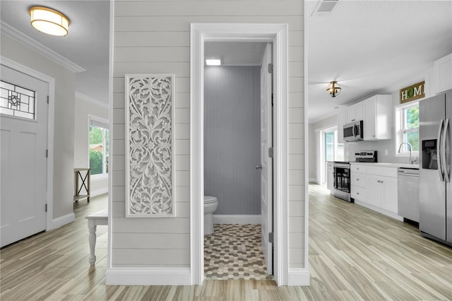 3721 Casaba Loop, Valrico, FL 33596 - foyer featuring crown molding, healthy amount of natural light, and light wood-type flooring