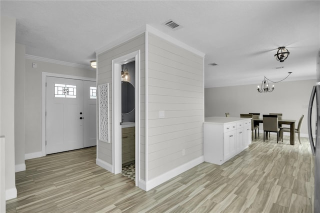3721 Casaba Loop, Valrico, FL 33596 - foyer with a chandelier, light wood-style floors, and ornamental molding