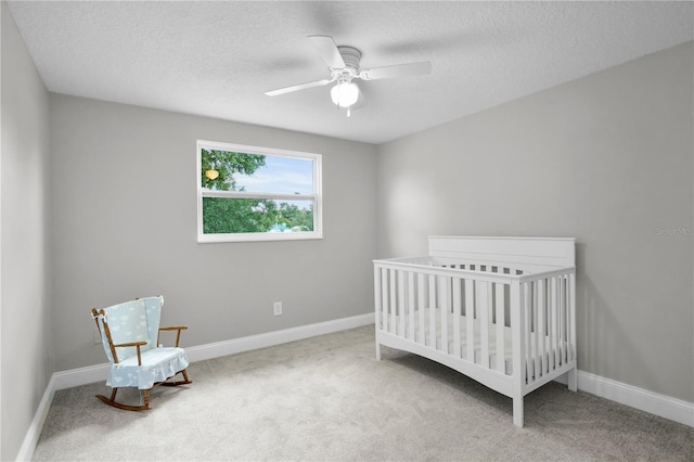 3721 Casaba Loop, Valrico, FL 33596 - carpeted bedroom with a textured ceiling, ceiling fan, and a crib