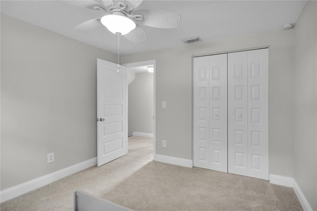 3721 Casaba Loop, Valrico, FL 33596 - unfurnished bedroom featuring carpet floors, a closet, ceiling fan, and a textured ceiling
