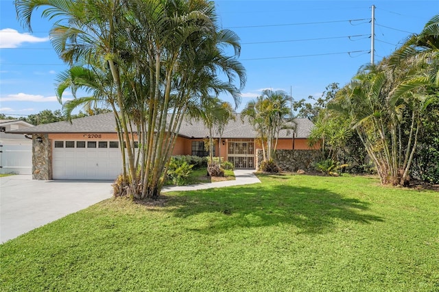 2708 W Bird St, Tampa, FL 33614 - ranch-style house featuring a garage, concrete driveway, a front yard, and roof with shingles