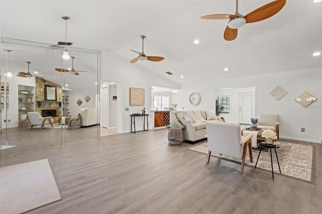 2708 W Bird St, Tampa, FL 33614 - living room with a ceiling fan, a fireplace, wood finished floors, high vaulted ceiling, and recessed lighting