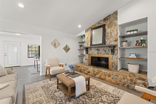 2708 W Bird St, Tampa, FL 33614 - living room with wood finished floors, a textured ceiling, a fireplace, recessed lighting, and lofted ceiling