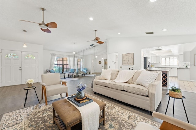 2708 W Bird St, Tampa, FL 33614 - living room with ceiling fan, lofted ceiling, light wood-style floors, recessed lighting, and a textured ceiling