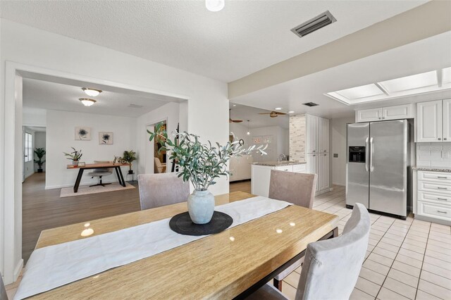 2708 W Bird St, Tampa, FL 33614 - dining area featuring light tile patterned flooring and baseboards