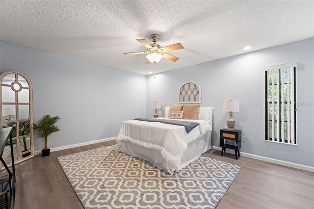 2708 W Bird St, Tampa, FL 33614 - bedroom featuring wood finished floors, a ceiling fan, a textured ceiling, and recessed lighting