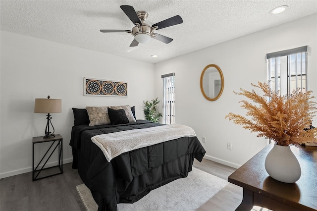 2708 W Bird St, Tampa, FL 33614 - bedroom with wood finished floors, a textured ceiling, a ceiling fan, and recessed lighting