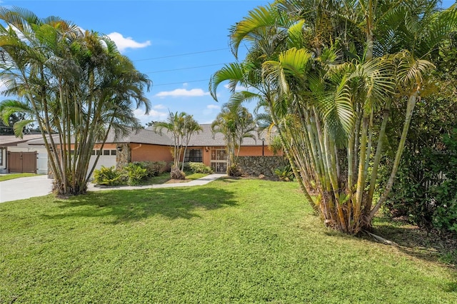 2708 W Bird St, Tampa, FL 33614 - view of grassy yard with concrete driveway and a garage