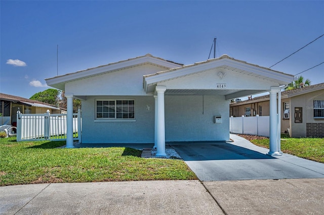 4849 Floramar Ter, New Port Richey, FL 34652 - view of front of house with concrete driveway, an attached carport, and stucco siding