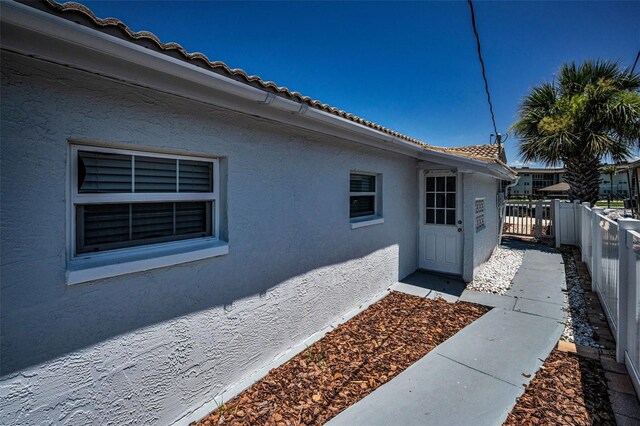 4849 Floramar Ter, New Port Richey, FL 34652 - view of home's exterior featuring stucco siding and a tiled roof