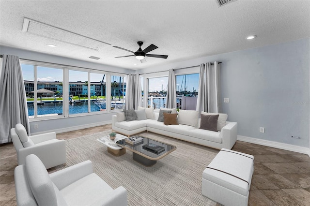 4849 Floramar Ter, New Port Richey, FL 34652 - living area with ceiling fan, a textured ceiling, a water view, attic access, and recessed lighting