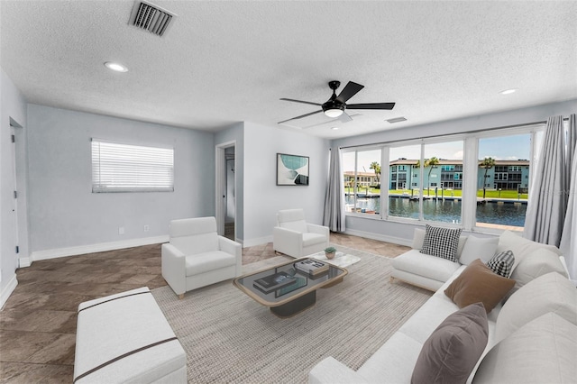 4849 Floramar Ter, New Port Richey, FL 34652 - living area featuring a textured ceiling, a water view, a ceiling fan, and recessed lighting