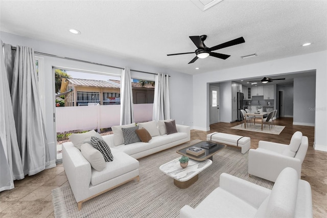 4849 Floramar Ter, New Port Richey, FL 34652 - living room featuring ceiling fan, recessed lighting, and a textured ceiling